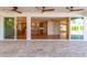 Expansive patio with ceiling fans and sliding doors leading to the bright interior of the home at 16227 N 63Rd Pl, Scottsdale, AZ 85254