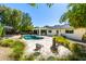 Inviting backyard oasis featuring a sparkling pool, brick patio, mature trees, and comfortable seating areas at 16227 N 63Rd Pl, Scottsdale, AZ 85254