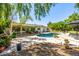 Stunning backyard featuring a refreshing pool, covered patio, lush landscaping, and plenty of room for entertaining at 16227 N 63Rd Pl, Scottsdale, AZ 85254
