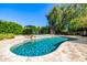 Stunning backyard pool with water features, lounge seating, and mature trees for shade and privacy at 16227 N 63Rd Pl, Scottsdale, AZ 85254