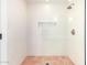 Tiled shower with a showerhead, glass doors, and a built-in niche for storage at 16227 N 63Rd Pl, Scottsdale, AZ 85254