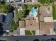 Overhead view of a beautiful home featuring a backyard pool, patio area, manicured lawn, and a neatly paved driveway at 1640 E Solano Dr, Phoenix, AZ 85016