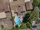 Aerial shot of a sparkling blue pool and backyard with a patio and lush landscaping in a private residential setting at 1640 E Solano Dr, Phoenix, AZ 85016