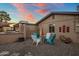 Cozy backyard seating area with stone landscaping, a built-in BBQ, and comfortable chairs for outdoor entertaining at 1640 E Solano Dr, Phoenix, AZ 85016