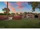 Manicured backyard featuring lush green grass and covered outdoor seating, ideal for entertaining and relaxing at 1640 E Solano Dr, Phoenix, AZ 85016