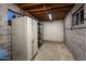 Unfinished basement with concrete walls and exposed ceiling, providing ample storage space and potential for customization at 1640 E Solano Dr, Phoenix, AZ 85016