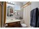 Cozy bathroom featuring a vanity with sink and a shower with curtain, creating a functional space at 1640 E Solano Dr, Phoenix, AZ 85016
