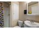 Compact bathroom with a shower stall, toilet, and sink with a mirrored vanity and modern fixtures at 1640 E Solano Dr, Phoenix, AZ 85016