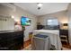 Bedroom featuring hardwood floors, dark decor, and a wall mounted flatscreen TV at 1640 E Solano Dr, Phoenix, AZ 85016