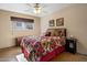 Comfortable bedroom featuring natural light, neutral walls, and a floral bedspread at 1640 E Solano Dr, Phoenix, AZ 85016