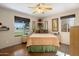 Bright bedroom with large windows, neutral walls, and a striped bedspread at 1640 E Solano Dr, Phoenix, AZ 85016