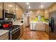 Well-lit kitchen with modern appliances, ample wooden cabinetry, and terracotta tile flooring at 1640 E Solano Dr, Phoenix, AZ 85016