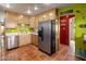 Bright kitchen featuring wooden cabinets, stainless steel appliances, and terracotta tile flooring at 1640 E Solano Dr, Phoenix, AZ 85016