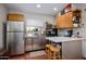 Efficient kitchen with stainless steel appliances, including a refrigerator and a sleek countertop island at 1640 E Solano Dr, Phoenix, AZ 85016