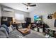 Cozy living room area with comfortable seating, a flatscreen TV, and shelving at 1640 E Solano Dr, Phoenix, AZ 85016
