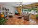 Cozy living room with terracotta tile flooring, comfortable seating, and large windows offering plenty of natural light at 1640 E Solano Dr, Phoenix, AZ 85016