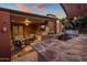 Impressive outdoor kitchen with bar seating, grill, and relaxing living area with seating and fireplace at 1640 E Solano Dr, Phoenix, AZ 85016