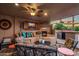 Relaxing outdoor living area with comfortable seating, a fireplace, TV, and a built-in bar at 1640 E Solano Dr, Phoenix, AZ 85016