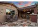 Inviting outdoor space with tile flooring, comfortable seating, and an outdoor living area with television at 1640 E Solano Dr, Phoenix, AZ 85016