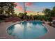 Backyard view showcasing a pool surrounded by rock features, built-in seating and a leafy perimeter at 1640 E Solano Dr, Phoenix, AZ 85016