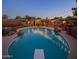 Inviting backyard featuring a sparkling pool, diving board, swim-up bar, and string lights, perfect for outdoor entertaining at 1640 E Solano Dr, Phoenix, AZ 85016