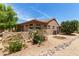 Well-maintained backyard featuring desert landscaping and a partial view of a golf course at 17406 N Escalante Ln, Surprise, AZ 85374