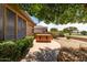 Backyard with desert landscaping, a hot tub, and partial view of a well-manicured golf course at 17406 N Escalante Ln, Surprise, AZ 85374