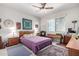 Bedroom with a ceiling fan, built-in desk and shelving, and an area rug at 17406 N Escalante Ln, Surprise, AZ 85374