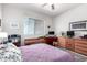 Bedroom with a ceiling fan, built-in desk and shelving, and an area rug at 17406 N Escalante Ln, Surprise, AZ 85374