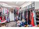 Walk-in closet featuring custom shelving and ample clothing storage at 17406 N Escalante Ln, Surprise, AZ 85374