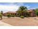 Inviting home with desert landscaping, a three-car garage, and a tile roof at 17406 N Escalante Ln, Surprise, AZ 85374