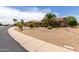 Beautiful house with a three-car garage, desert landscaping, and mature trees at 17406 N Escalante Ln, Surprise, AZ 85374