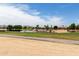 Scenic view of the golf course with a serene lake and residential homes in the background at 17406 N Escalante Ln, Surprise, AZ 85374