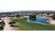 Scenic golf course view with water feature and well-maintained green, near residential area at 17406 N Escalante Ln, Surprise, AZ 85374