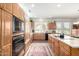 Kitchen with light wood cabinets, a built-in oven, and a view of the garden and casual seating area at 17406 N Escalante Ln, Surprise, AZ 85374