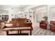 Elegant living room with a grand piano, comfortable seating, and a welcoming entryway at 17406 N Escalante Ln, Surprise, AZ 85374
