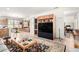 Spacious living room featuring a built-in entertainment center and an open layout to the dining area at 17406 N Escalante Ln, Surprise, AZ 85374