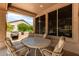 Charming covered patio with comfortable seating and a built-in grill for outdoor entertaining at 17406 N Escalante Ln, Surprise, AZ 85374