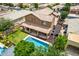 Aerial view of backyard featuring a pool, playground, covered patio, desert landscaping and AC units at 1876 E Azalea Ct, Gilbert, AZ 85298