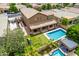Aerial view of a backyard oasis featuring a pool, playground, covered patio, and desert landscaping at 1876 E Azalea Ct, Gilbert, AZ 85298