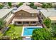 Aerial view of backyard with pool, playground and covered patio with outdoor kitchen and dining at 1876 E Azalea Ct, Gilbert, AZ 85298