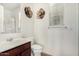 This well-lit bathroom features a shower, decorative metal flowers, and modern fixtures at 1876 E Azalea Ct, Gilbert, AZ 85298