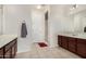Bright bathroom features double sinks, neutral tile floor, white door and walk in shower at 1876 E Azalea Ct, Gilbert, AZ 85298
