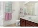 Bright bathroom featuring tile floors, vanity, mirror, and a window at 1876 E Azalea Ct, Gilbert, AZ 85298
