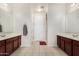 Bright bathroom features double sinks, neutral tile floor, white door and walk in shower at 1876 E Azalea Ct, Gilbert, AZ 85298