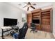 This bedroom features an expansive built-in bookshelf and a comfortable gaming setup at 1876 E Azalea Ct, Gilbert, AZ 85298