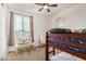 Cozy bedroom featuring a window, bunk beds, and ceiling fan at 1876 E Azalea Ct, Gilbert, AZ 85298