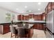 Kitchen with granite countertops, a center island with seating, and stainless steel appliances at 1876 E Azalea Ct, Gilbert, AZ 85298