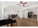 Open floor plan featuring wood flooring, a piano, dining area, and a staircase at 1876 E Azalea Ct, Gilbert, AZ 85298