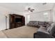 Inviting living room with carpet floors, a large dark wood entertainment center and neutral walls at 1876 E Azalea Ct, Gilbert, AZ 85298